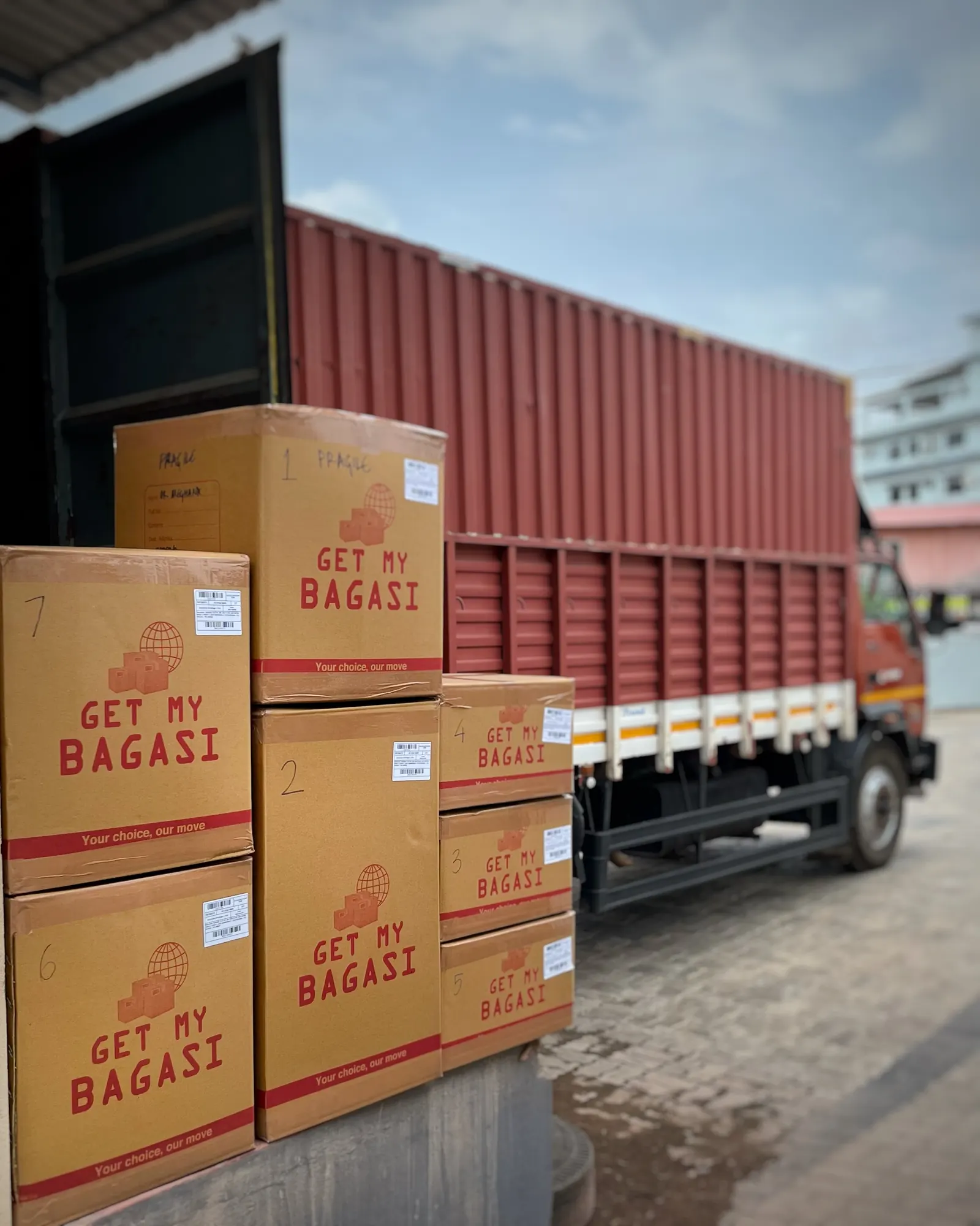 Cartons beside an open container at the loading bay
